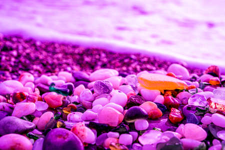 Colorful sea glass found on the coast in crimson fluorescent light. High quality photoの写真素材