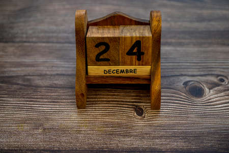 Wooden calendar with christmas 24 december date in french language. Seasonal holiday concept. Eve...