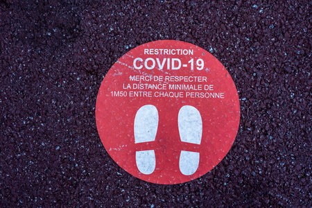 Footprint floor sticker, foot steps in circle, keep distance waiting in line, stand here sign, coronavirus or Covid-19 prevention, social distance. High quality photoのeditorial素材
