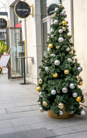 Villeneuve-Loubet, France 01.12.2020 Golden and Silver color of Christmas ball on the branches fir, Decorated Christmas tree. New Year Decoration festive background with vintage tone and selective focus. High quality photoのeditorial素材