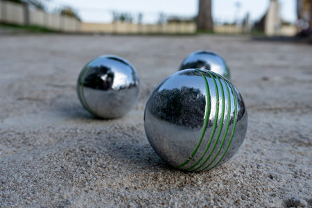 Close-up of steel balls for petanque on a gravel surface, France. Selective focus. High quality...