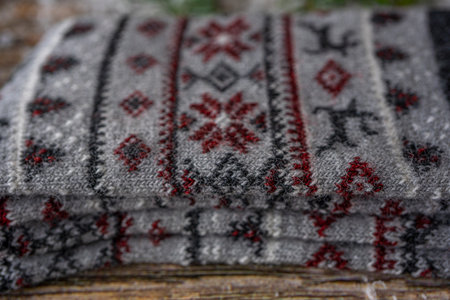 Warm knitted woolen winter socks for man. Christmas decoration on wooden background, flat lay.