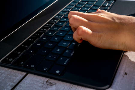 Nice, France - 01.29.2021: New iPad Pro 12.9 inches from Apple on a light background. Tablet Computer on a Wooden background. Boy teenager pressing keys on Apple iPad. High quality photo.のeditorial素材