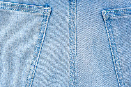 Backside denim blue jeans pocket closeup. Denim jeans texture. Blue jeans texture with pocket for any background. High quality photoの写真素材