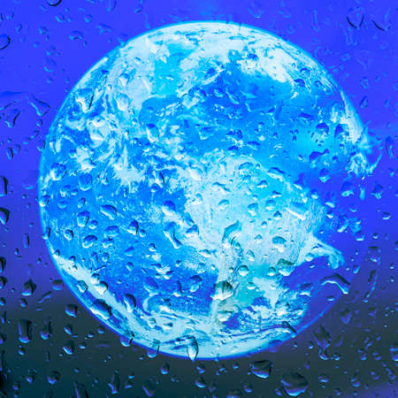 Planet earth at night with raindrops in the foreground.  . Soft focus background. High quality photoの写真素材