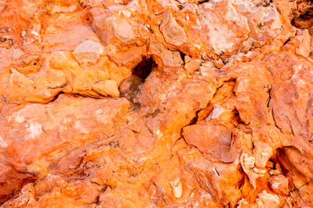 Light red-orange stone texture. Red orange grunge background. Mountain texture macro close-up....