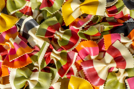Different types of Italian colorful dry pasta as background. Macro close up.
