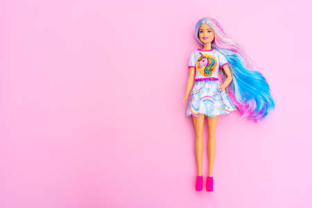 Nice, FRANCE - 12.04.2021: Portrait of blond rainbow Barbie doll against pink background. High quality photoのeditorial素材