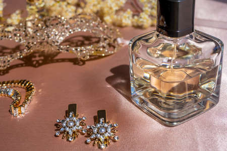 Luxe perfume in beautiful bottle with accessory on toilet table. Selective focus. Luxury beauty...