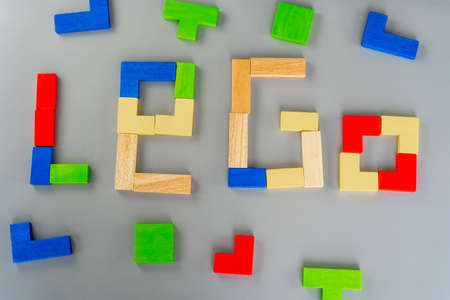 Wooden cube on the gray background. Multi-colored cubes on the table. Geometric shapes on a wooden background. Puzzle concept. High quality photoの写真素材