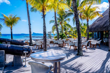 Mauritius Island - 04.11.2021 : Canonnier Beachcomber Hotel. Tropical paradise island holidays on the hotel, sea view with beach chairs and sun umbrellas. Hight quality photoのeditorial素材