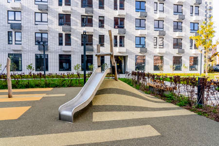 Moscow, Russia - 04.10.2021: Beautiful multi colorful building of new modern residential area for young families. Playground in public yard. Residential district with bright facade geometry.のeditorial素材
