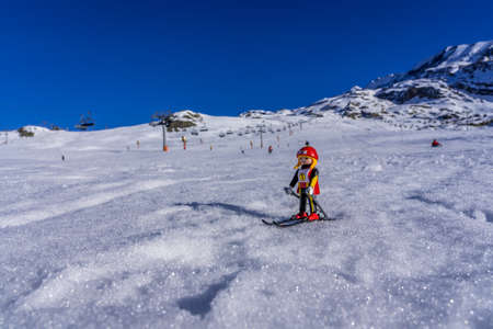 Alpes dHuez, France - 01.01.2022: Lego plastic toy skier on the real ski french resort, winter snow mountains background. High quality photoのeditorial素材