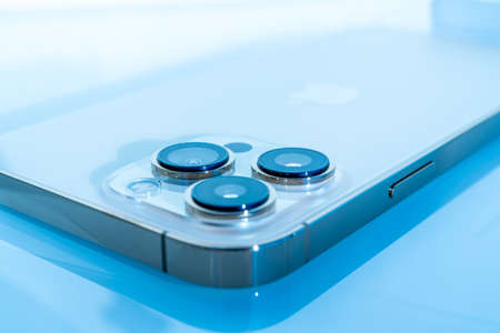 Nice, France - 13.12.2021 The new smartphone of the iPhone 13 Pro Max. Blurred blue background,...