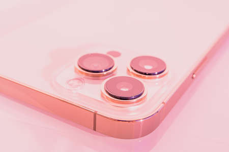 Nice, France - 13.12.2021 The new smartphone of the iPhone 13 Pro Max. Blurred pink background, macro close up. Three close-up phone cameras. New technology concept. High quality photoのeditorial素材