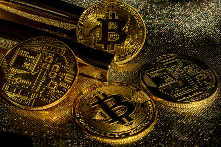 Golden crypto coins on a gold background. Bitcoin cryptocurrency with altcoins and shitcoins. High...