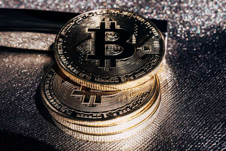 Golden crypto coins on a gold background. Bitcoin cryptocurrency with altcoins and shitcoins. High...
