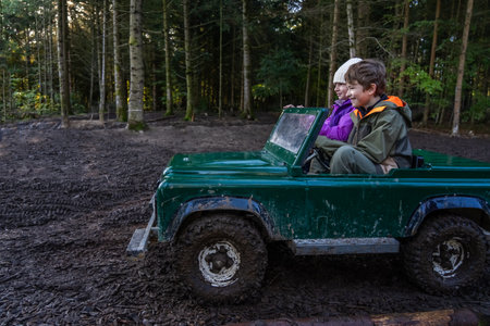 Children ride in an open iron childrens car. Extreme form of entertainment for children. The boy...