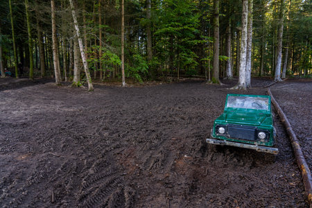 Open iron childrens car in the forest on a dirty road. Extreme form of entertainment for children....