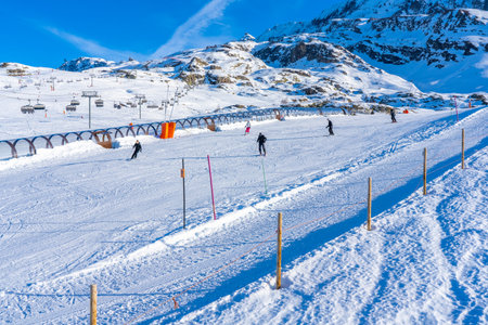 Alpes d'Huez, France - 31.12.2021: Magicagic carpet ski lift in a glass tunnel. Snowy winter day in the french ski resort. Hight quality photoのeditorial素材