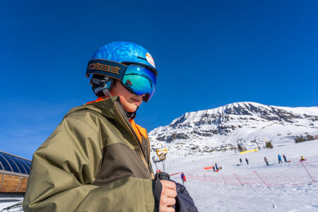 Alpe D'Huez, FRANCE - 01.01.2022: Boy skier posing on a mountain, holidays with children in the snow mountains concept. Famous ski resort in French Alps, France, Europe. Wintertimeのeditorial素材