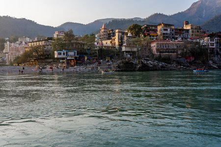Rishikesh, Uttarakhand, India - 28.03.2023: Beautiful River Ganga in Rishikesh surrounded by ashrames and temples building. Pure natural clean river water. High quality photoのeditorial素材