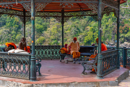 Rishikesh, Uttarakhand, India - 28.03.2023: Group of bearded pilgrim in orange clothes. High quality photoのeditorial素材