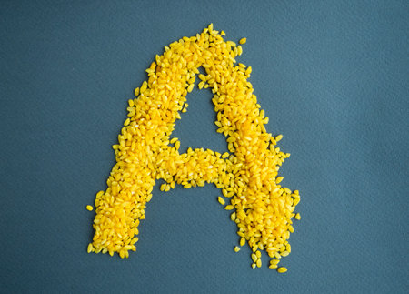 Photo letter A made from yellow rice.の写真素材