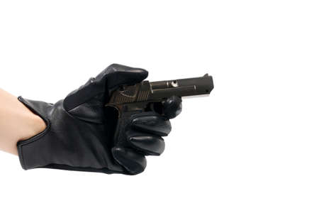 The hand in a black glove with a gun, isolated on white backgroundの写真素材