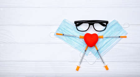 Medical masks, homeopathic remedies lying on white background.Healthy heart. Heart vascular system. Copy space. Concept of prevention,diagnosis and treatment of virusの写真素材