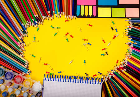 Education background. Supplies for school border on yellow desk, panorama with empty space. Top...