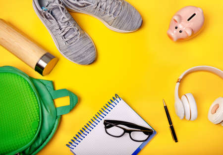 Smartphone, headphones and office accessories on a yellow background. Modern lifestyle. Business....