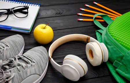 Healthy lifestyle background. Concept of an active lifestyle, sports, fitness, health. Sneakers, bottle of waters, smartphone, headphone, notebook diary on black background. Top view, flat lay, copy spaceの写真素材