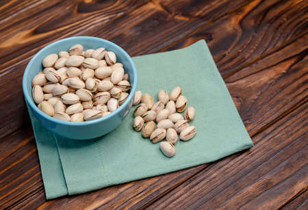 Pistachios nuts in bowl. Pistachio background. Healthy food, snacks, vegetarian food. Top view, copy...