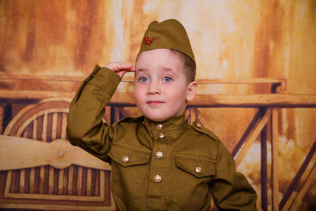 Funny boy are dressed as soldier in retro military uniforms. Little boy on the holiday of May 9, the...