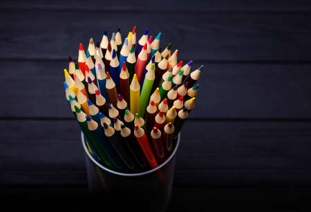 Color pencils in the stand holder on the wood vintage background. Macro with extremely shallow depth of fieldの写真素材