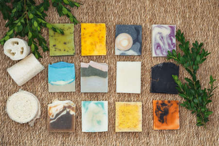 Natural soap with spa accessories. Stacks homemade bars of soap with herbal material. Bars of...