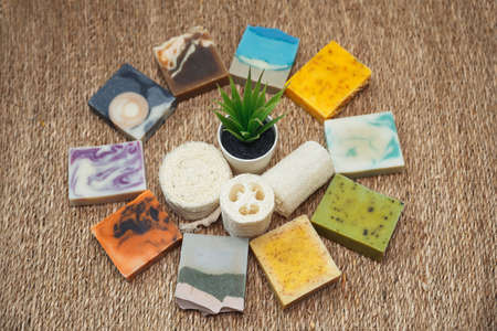 Moisturizing skin care and aromatherapy. Handmade soap bar with coconut oil. Concept of using natural oil in cosmetology. Gentle body treatment. Atmosphere of harmony and relax. Straw backgroundの写真素材
