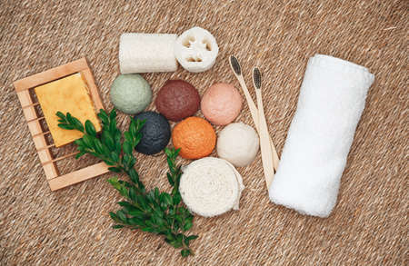 Natural organic and biodegradable products for face and body care. Bamboo toothbrushes, konjac sponge, natural organic products. Plastic free, zero waste cosmetics, flat lay. Overhead shotの写真素材