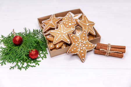 Homemade sweet present - variety of christmas gingerbread cookies in box, oranges, Xmas tree on...