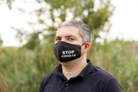 Portrait of a caucasian man in a medical face mask against air pollution. Coronavirus, COVID-19,...