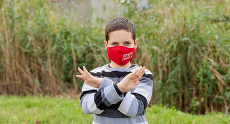 Teenager teen male child wearing face mask to protect himself from the flu and diseases. Portrait of...
