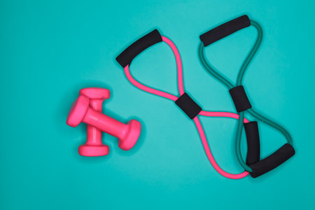 Fitness equipment for workout. Accessories on turquoise background. Sports tools , top view. Healthy...