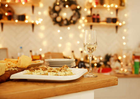 Still life on rustic wooden table. French food tasting party or feast scenery. Different kinds of cheeses, wine and snacks. Food for wine and romantic, cheese delicatessen. Menu design horizontalの写真素材
