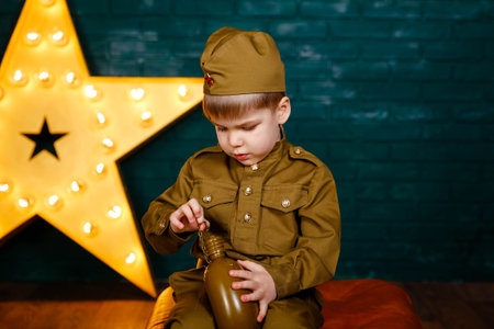 Soldier - the defender of the fatherland. Happy smiling child boy in military uniform. Little...