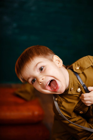 Surprised attractive boy. Smiling preschooler playing. Portrait of laughing child. Cheerful kid with expression emotions. Excited little boy. Cheering cute blonde boy. Young kid looking at the cameraの写真素材