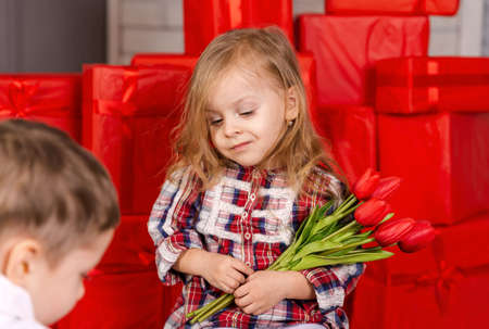 Attractive kid open gift birthday. Charming girl is surprised of happy birthday gift. Overjoyed...