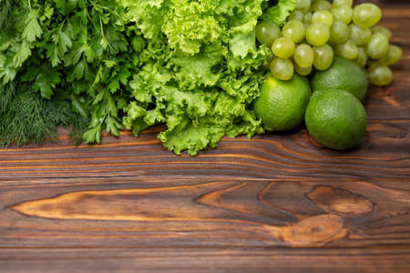 Fresh green vegetables and fruits. Salad leaves with arugula, lettuce, spinach. Fitness food cooking...