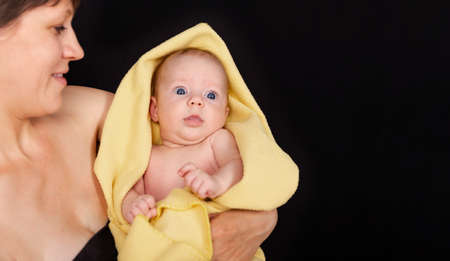Close up of baby hugging mother. Mother with her little infant. Mid adult woman holding her baby...