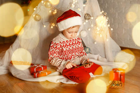 Greeting somebody. Virtual call. Christmas online family congratulations. Smiling european boy using...